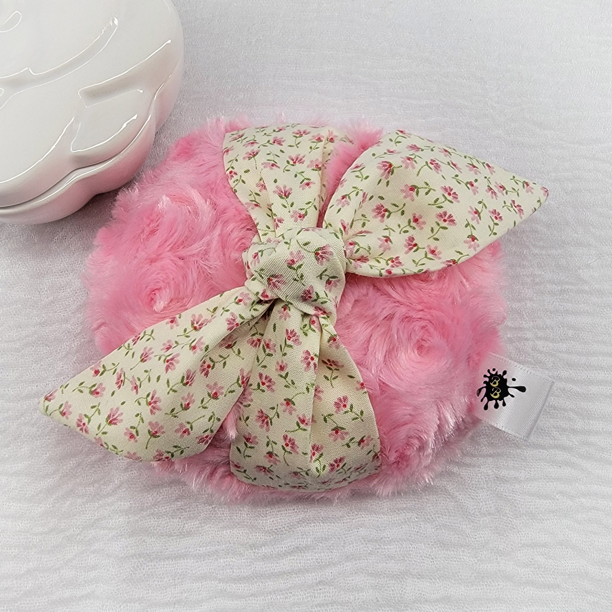 pink body powder puff with small ditzy flowers. Measures 4 inches across.